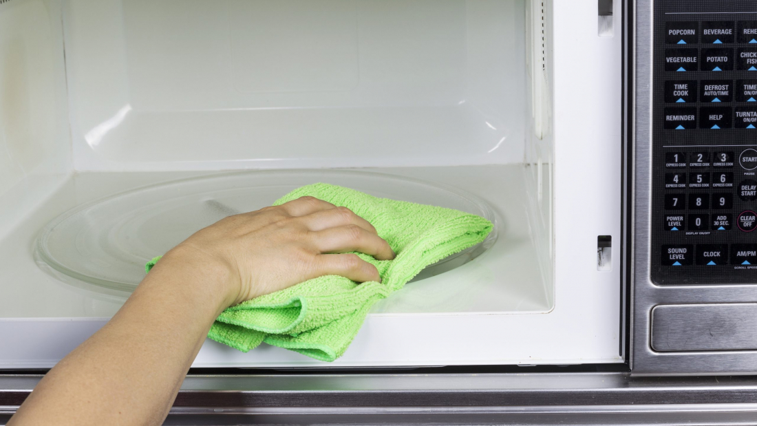 Hand,With,Microfiber,Cleaning,Rag,Wiping,Inside,Of,Microwave,Oven