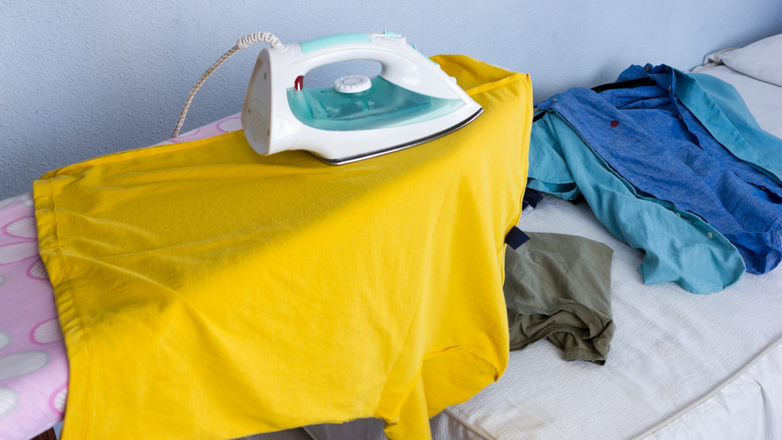 Ironing,Clothes,On,A,Yellow,T-shirt,On,The,Ironing,Board