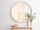 Big,Round,Mirror,,Table,With,Jewelry,And,Decor,Near,Brick
